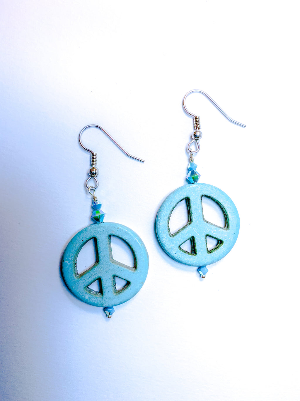 Turquoise colored peace charm and crystal earrings
